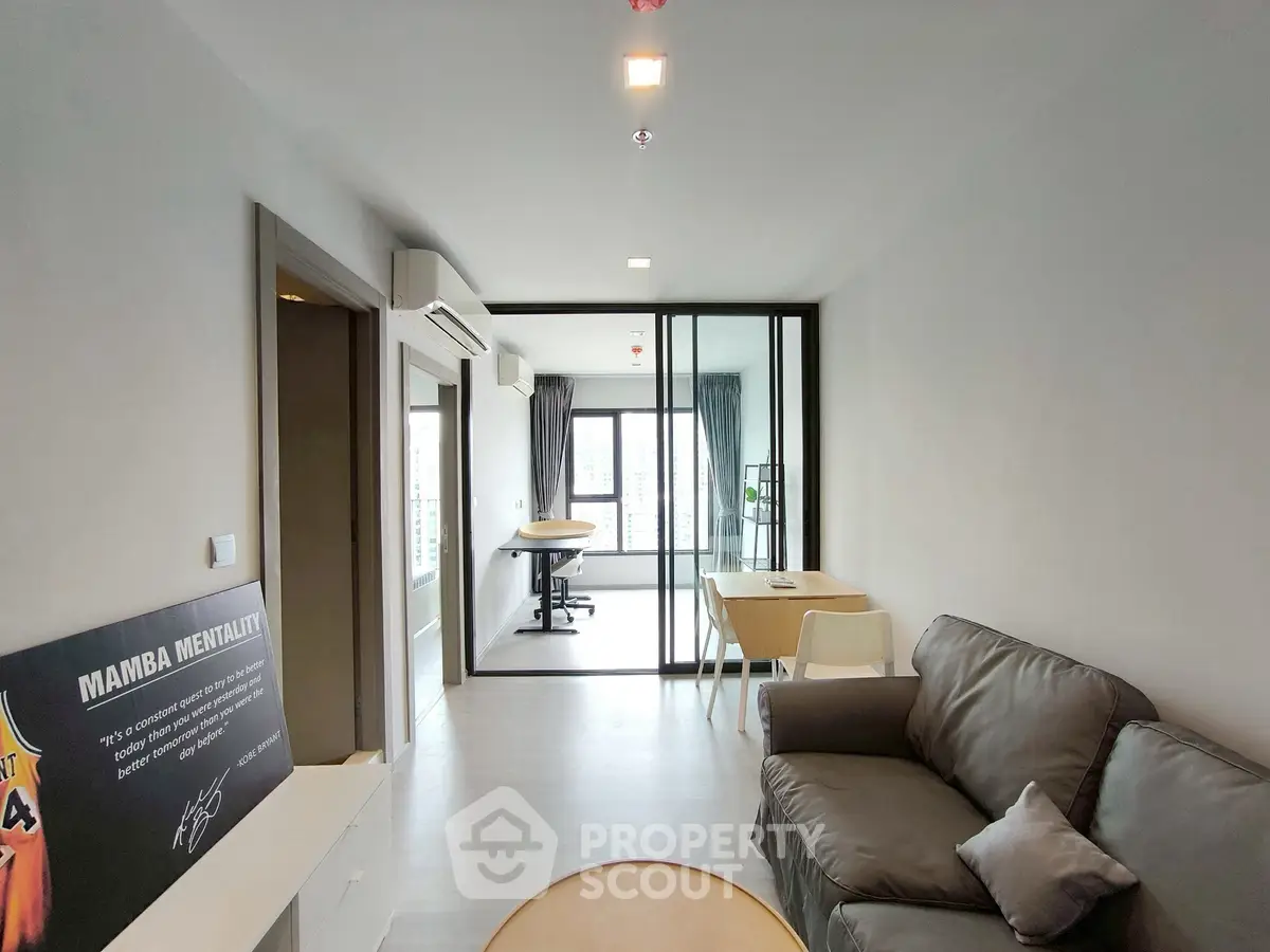 Modern living room with glass partition and cozy seating area