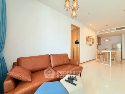 Modern living room with leather sofa and open kitchen layout