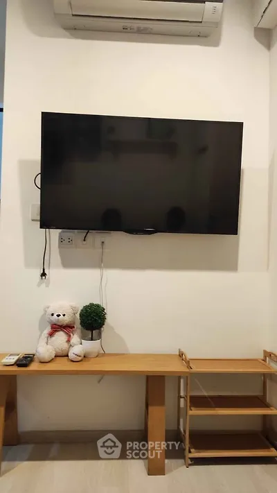 Cozy living room with wall-mounted TV and stylish decor