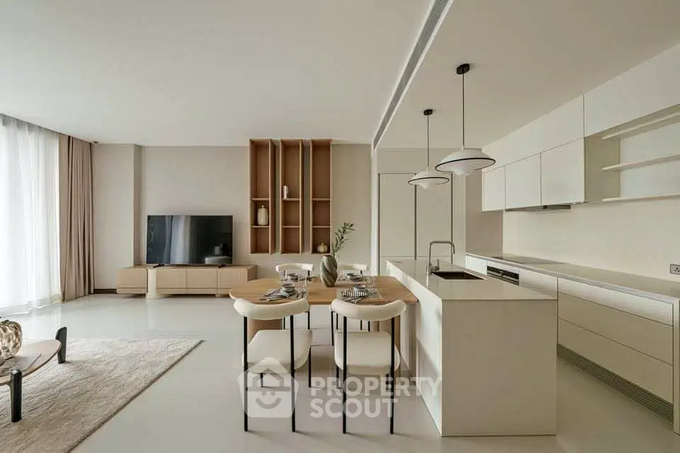 Modern open-plan living room and kitchen with sleek design and neutral tones