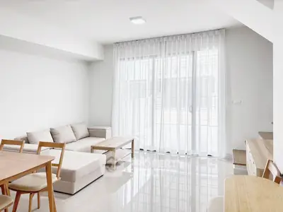 Bright and modern living room with sleek furniture and large windows for natural light.