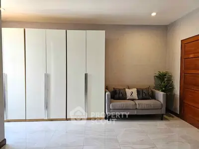 Spacious modern living room with sleek wardrobe and cozy sofa
