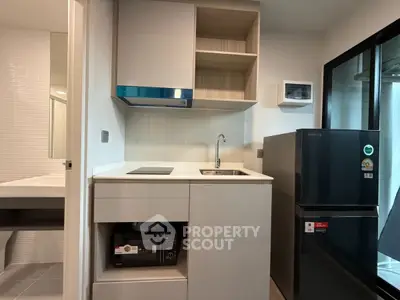 Modern compact kitchen with sleek appliances and stylish cabinetry