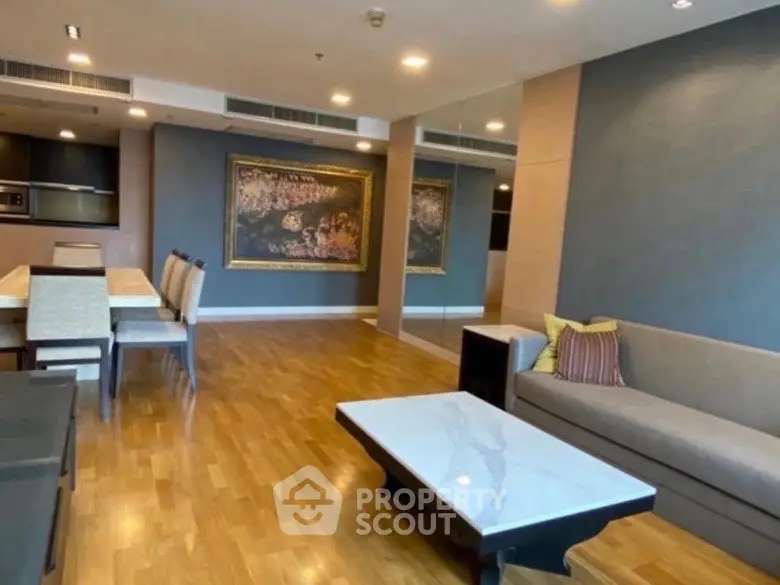 Spacious living room with elegant decor and dining area in modern apartment.