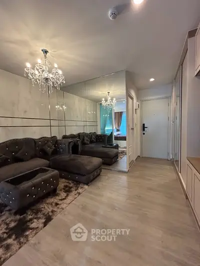 Luxurious living room with elegant chandelier and plush seating in modern apartment