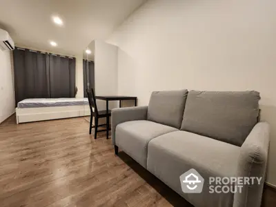 Modern studio apartment with cozy sofa and stylish bed, perfect for urban living.