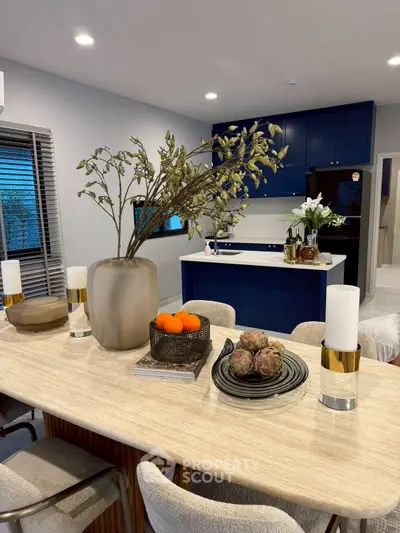 Modern dining area with elegant decor and view into stylish kitchen