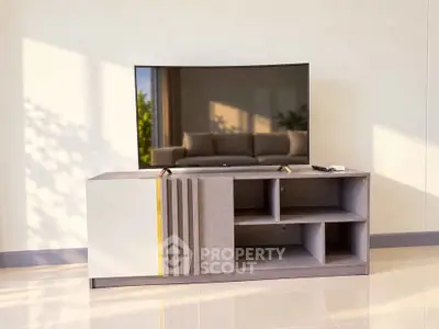 Modern living room with sleek TV stand and flat-screen TV, showcasing minimalist interior design.