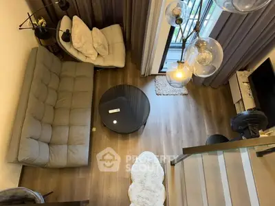 Modern living room with stylish furniture and large windows offering natural light.