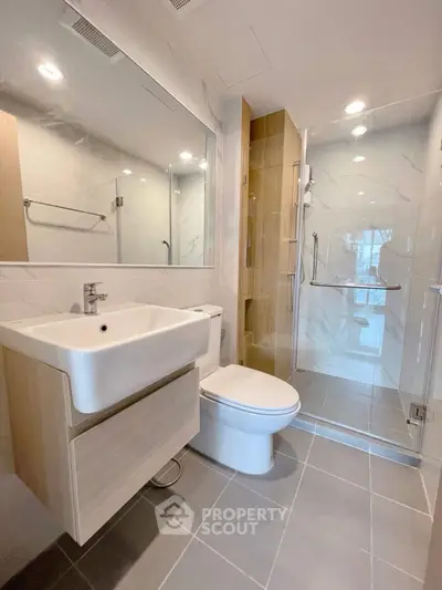 Modern bathroom with sleek fixtures and glass shower enclosure