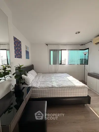 Bright and modern bedroom with large windows and stylish decor