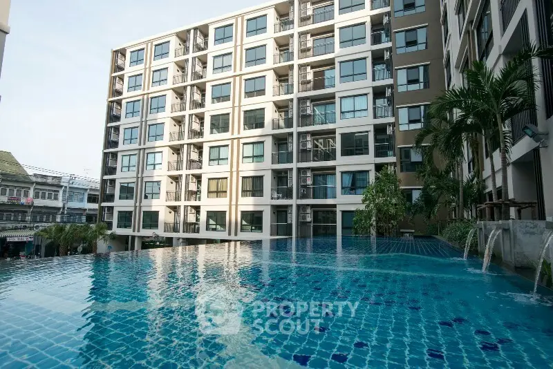 Modern apartment building with a stunning pool view, perfect for urban living.