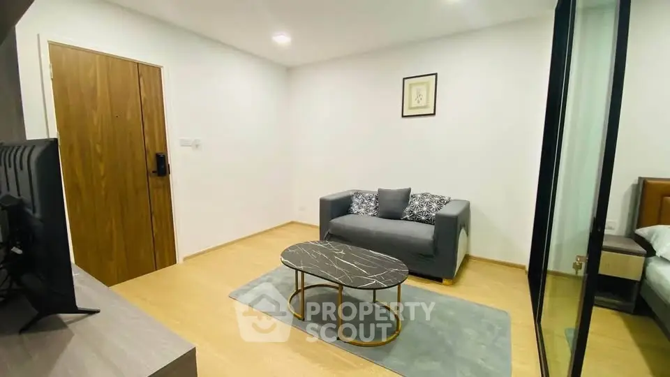 Modern living room with stylish sofa and marble coffee table in cozy apartment.