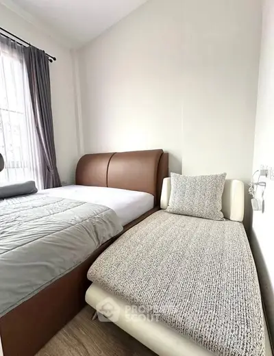 Cozy bedroom with modern furnishings and natural light, perfect for relaxation and comfort.