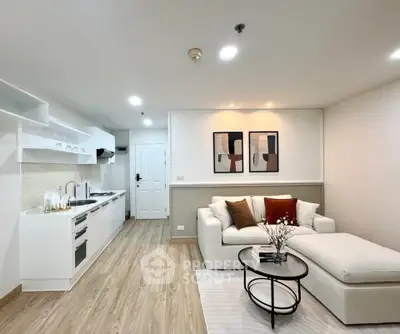 Modern open-layout living room with stylish kitchen and cozy seating area, perfect for urban living.