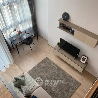 Modern living room with stylish furniture and large windows