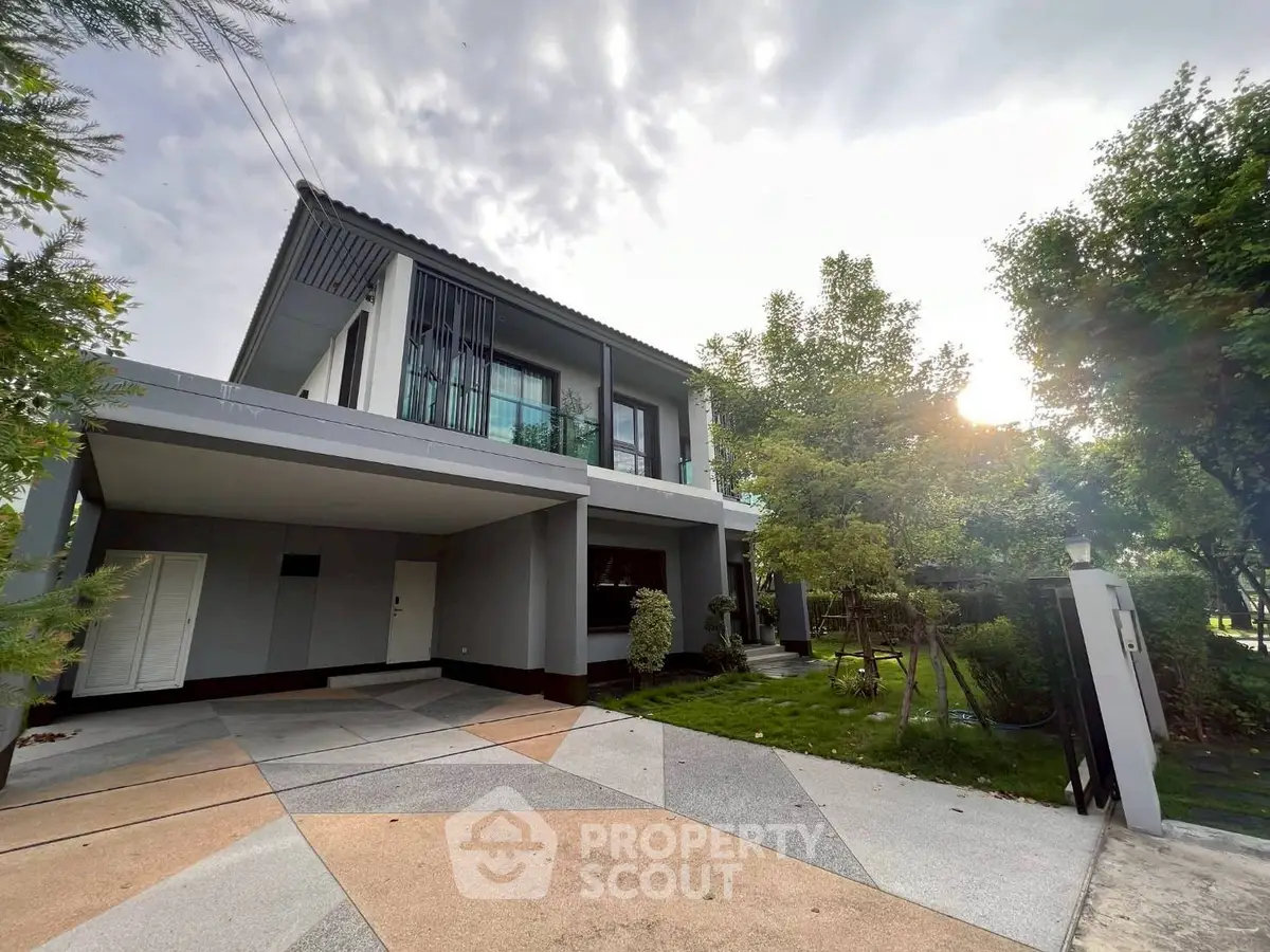 Modern two-story house with spacious driveway and lush greenery