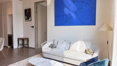 Modern living room with stylish decor and abstract art on the wall.