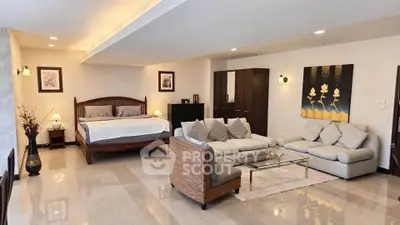 Spacious open-plan living room with elegant decor and cozy seating area