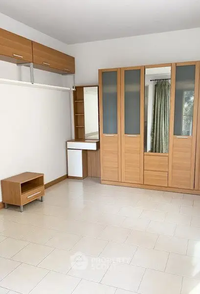 Spacious bedroom with built-in wardrobe and natural light