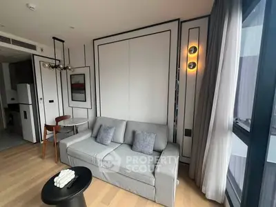 Modern living room with stylish decor and natural light in a contemporary apartment.