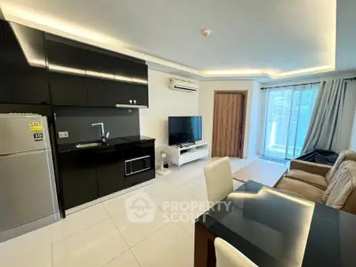 Modern open-layout living room with sleek kitchen and balcony access