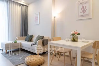 Chic living room with modern decor, cozy sofa, and elegant dining area in a stylish apartment.