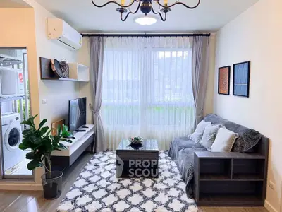 Charming living room with cozy sofa, modern decor, and natural light from large window.