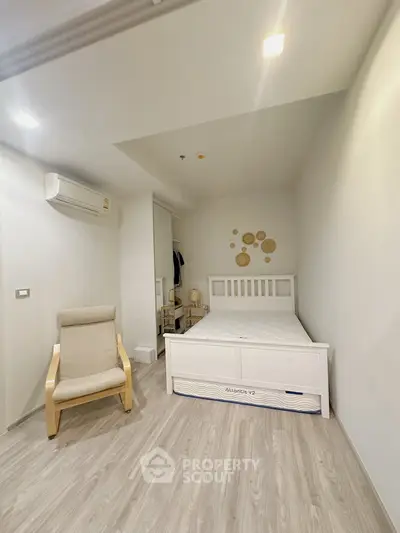 Cozy minimalist bedroom with modern decor and wooden flooring