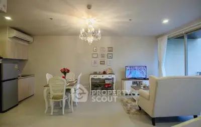 Elegant living room with chandelier, dining area, and cozy seating, perfect for modern living.
