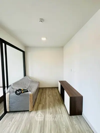 Modern minimalist living room with sleek wooden flooring and stylish furniture
