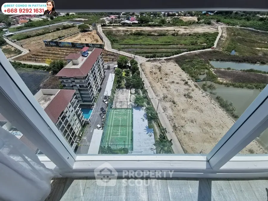 Stunning high-rise condo view with tennis court and lush surroundings in Pattaya