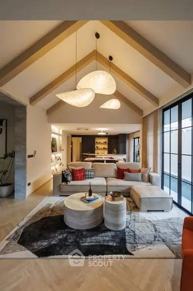 Stunning open-layout living room with modern decor and high ceilings, perfect for entertaining.