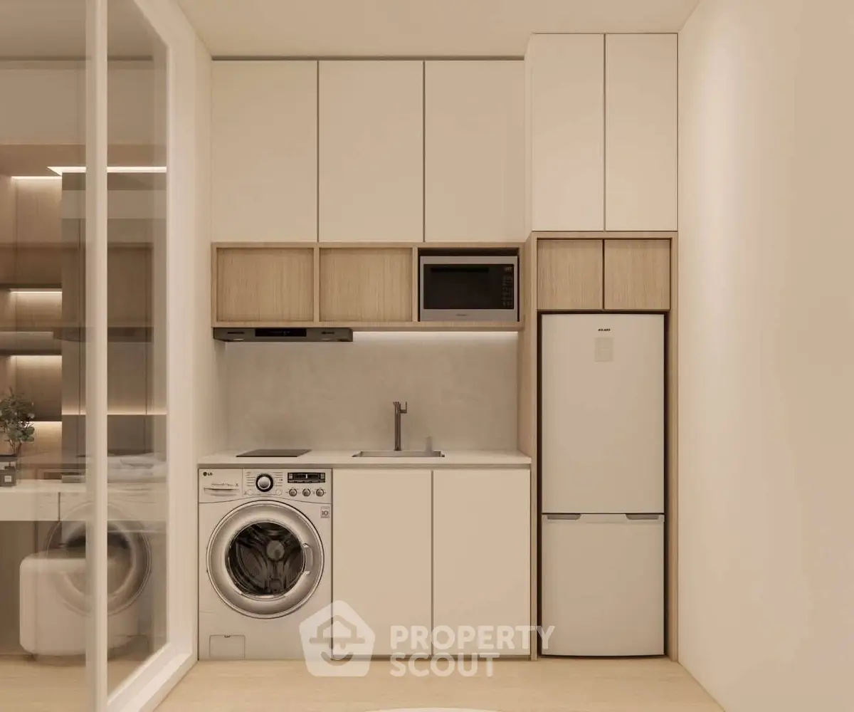 Modern kitchen with sleek appliances including washing machine, microwave, and fridge in a compact layout.
