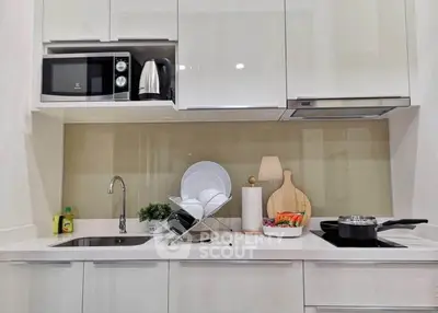 Modern kitchen with sleek cabinetry, built-in appliances, and stylish countertop accessories.