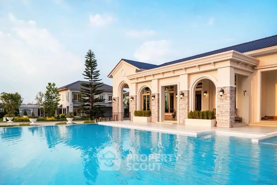 Luxurious villa with stunning pool and elegant architecture in serene setting.