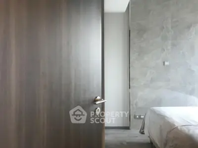 Modern bedroom with elegant marble wall and cozy bedding