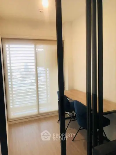 Bright study room with large window and modern furniture