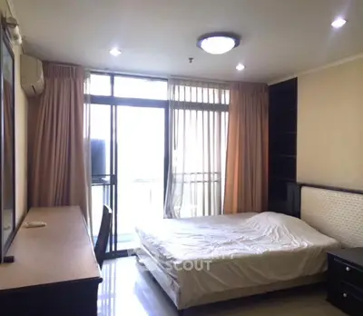 Spacious bedroom with balcony access and natural light