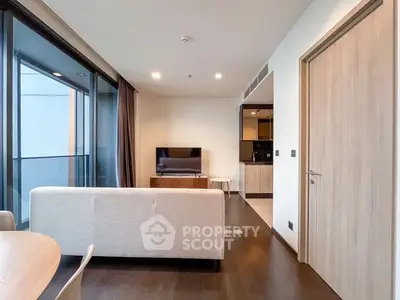 Modern living room with sleek furniture and large windows in a stylish apartment.