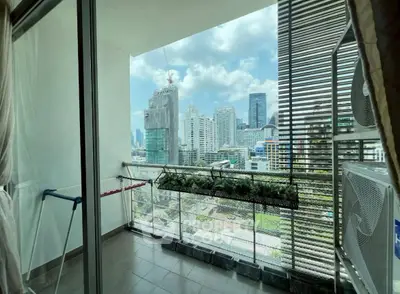 Spacious balcony with stunning city skyline view, perfect for relaxation and enjoying urban living.