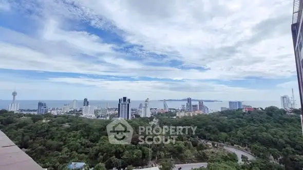 Stunning cityscape view with lush greenery and ocean horizon