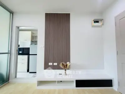 Modern minimalist living room with sleek design and open kitchen view