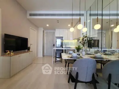 Modern open-plan living room with elegant dining area and stylish kitchen.