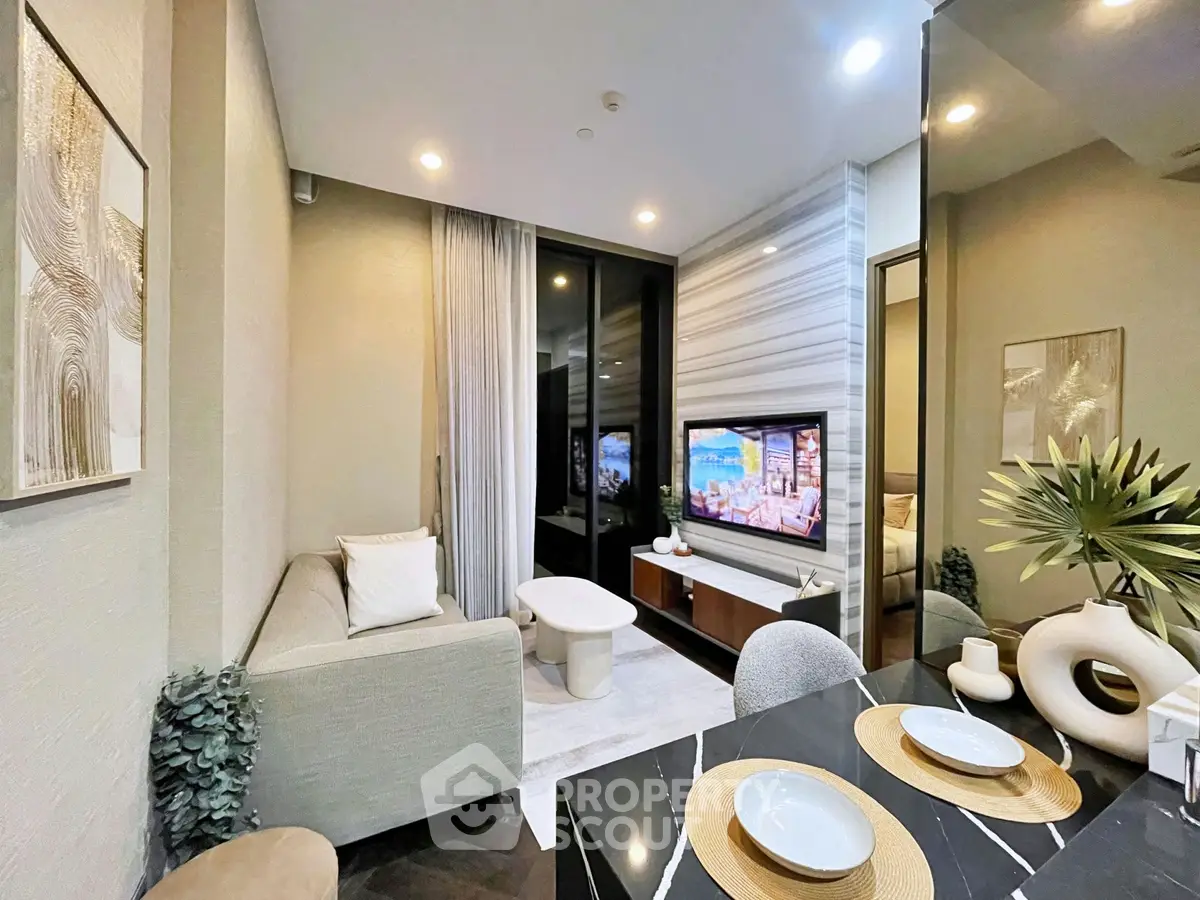 Modern living room with stylish decor and cozy ambiance, featuring a sleek TV setup and elegant dining area.