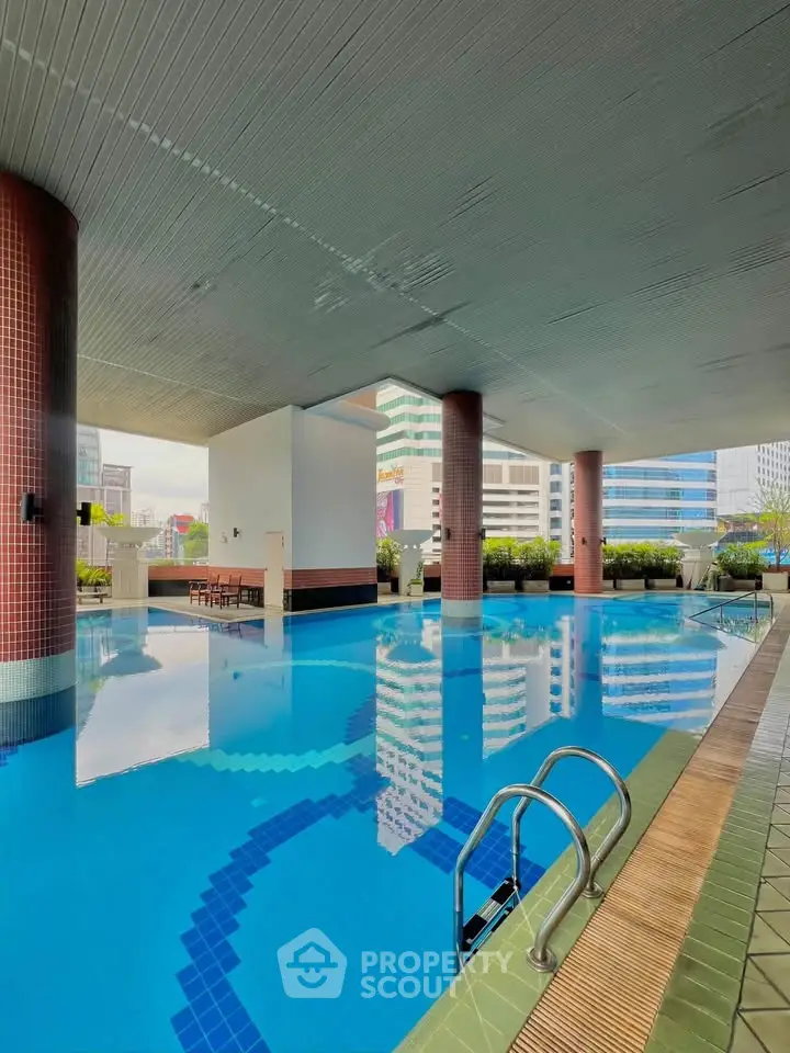 Luxurious urban swimming pool with cityscape views and modern design.
