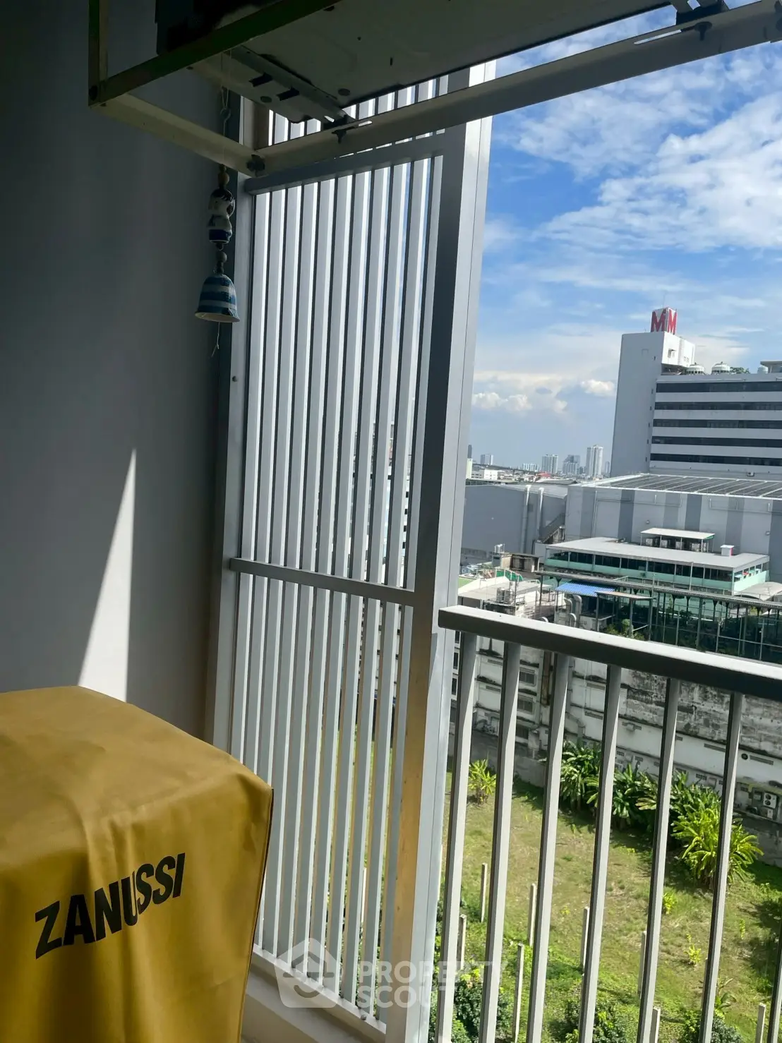 Urban balcony with city view and Zanussi appliance cover, perfect for modern living.