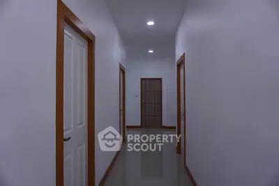 Spacious hallway with modern lighting and multiple doors