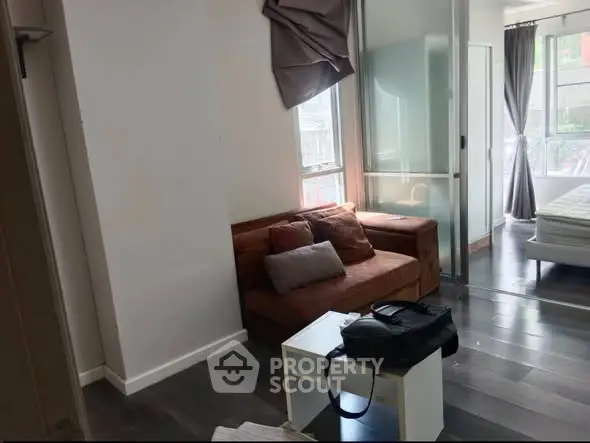 Modern apartment with cozy living area and bedroom, featuring stylish decor and natural light.