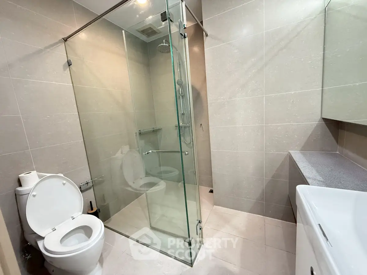 Modern bathroom with glass shower and sleek fixtures